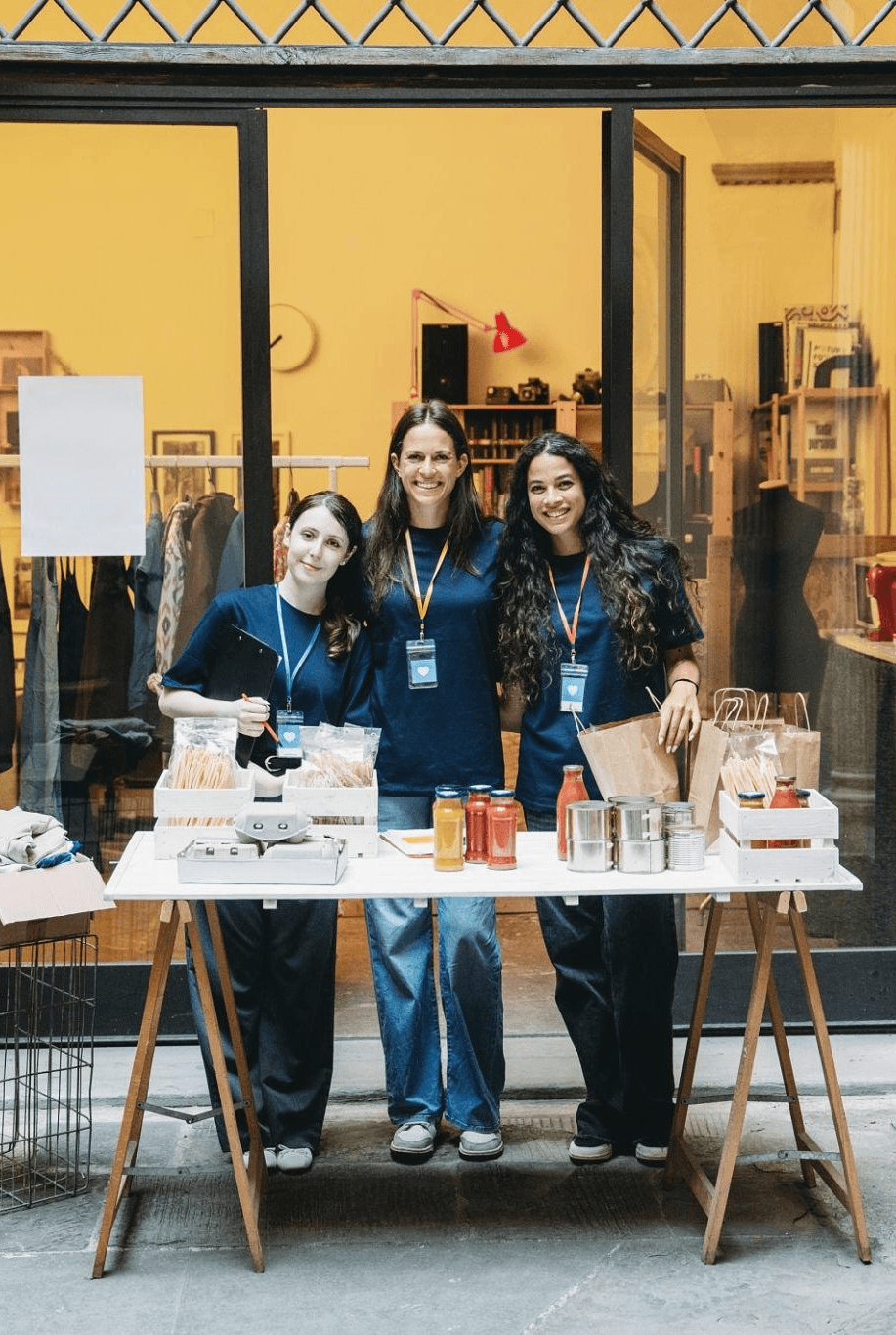 Volunteers selling items at a community fundraising table