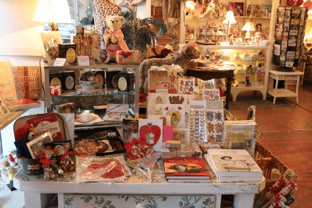 Gift shop display with books, toys, and handmade crafts