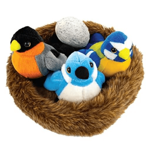 Plush bird toys in a soft nest