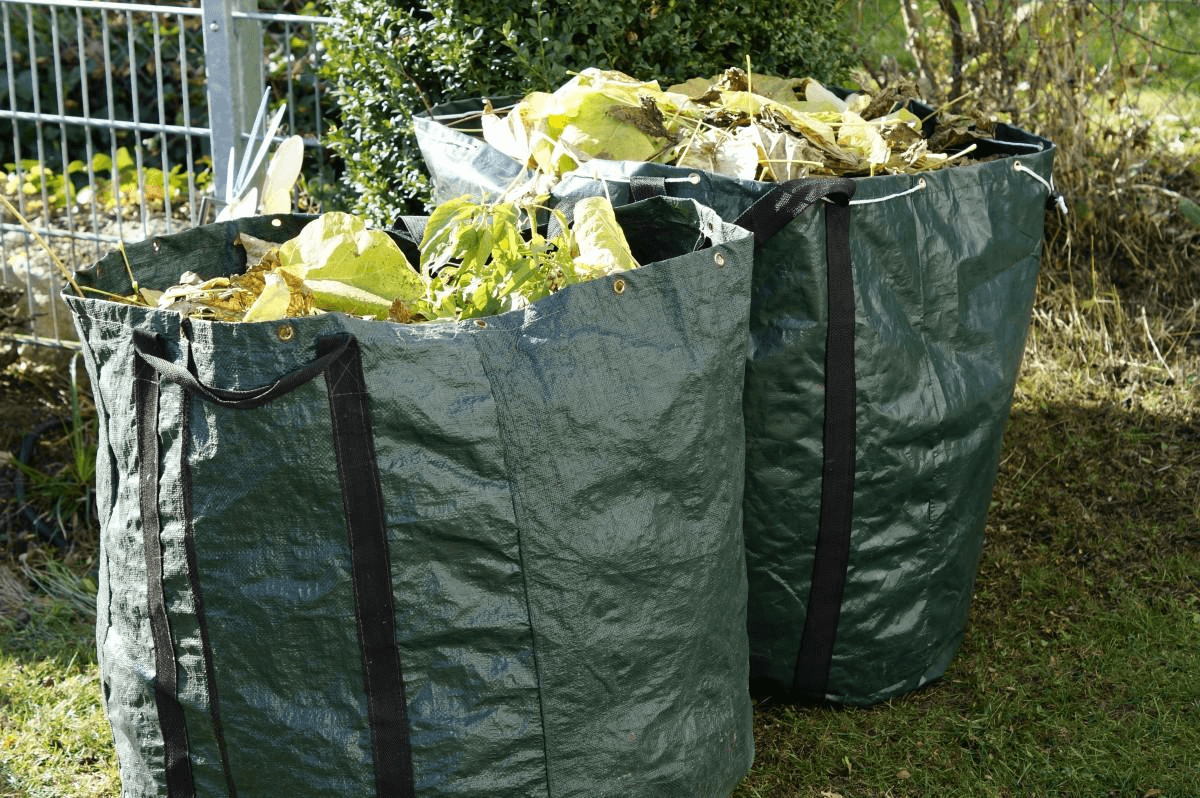 Reusable yard waste bags filled with plant debris